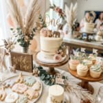 Soft Wild One first birthday dessert table with cake and sweets for a girl