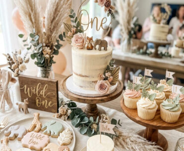 Soft Wild One first birthday dessert table with cake and sweets for a girl