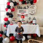 Modern race car third birthday party setup for a boy at home