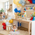 One year old in a Sesame Street-inspired outfit beside a stylish first birthday party setup