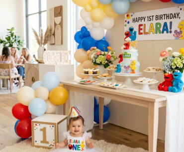 One year old in a Sesame Street-inspired outfit beside a stylish first birthday party setup