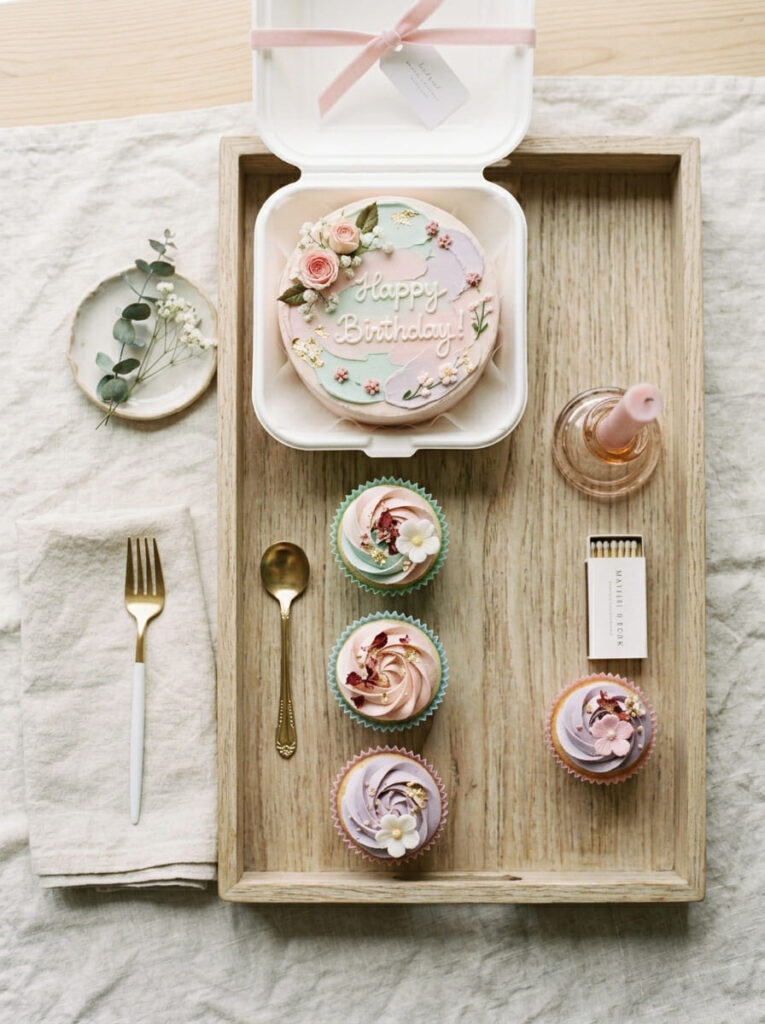 Bento cake with matching cupcakes in soft pastel colors